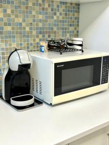 a microwave sitting on top of a counter at LAYA Old City in Bucharest +4 photos
