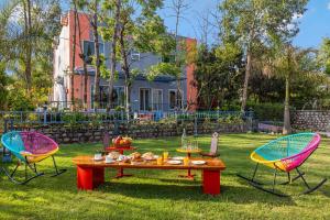 two chairs and a table with food on it in a yard at Corbett Calling with Projector Set-Up by StayVista in Rāmnagar