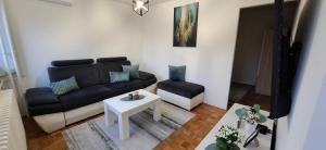 a living room with a couch and a table at Apartman Lamela in Zenica