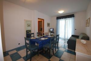 a dining room with a blue table and chairs at Mare Blu Residence in Martinsicuro