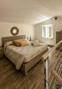 a bedroom with a bed and a mirror on the wall at Casina Miriano in Castiglione del Lago