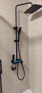 a shower with a shower head in a bathroom at Bulevar Mostar Old Bridge in Mostar +68 photos