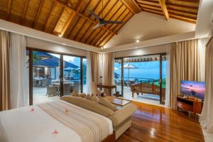 a bedroom with a large bed and a television at Karang Saujana in Uluwatu +279 photos