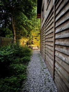 a wooden fence next to a path next to a yard at Nasze Calle in Węgorzewo +79 photos