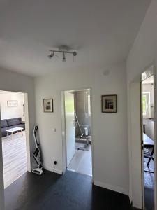 a white room with a room with a treadmill in it at Renovated Flat - Prime Location Near Marienplatz in Stuttgart