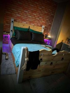 a bedroom with a large bed with a wooden headboard at The Alchemy in Bournemouth