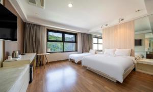 Postel nebo postele na pokoji v ubytování Wolmido Premiers Hotel