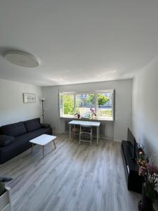 a living room with a couch and a table at Renovated Flat - Prime Location Near Marienplatz in Stuttgart