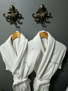 a pair of white sweaters hanging on a wall at The Alchemy in Bournemouth