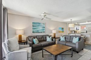 a living room with a couch and chairs and a table at Buena Vista 403 in Gulf Shores