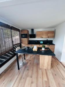 a kitchen with a large black table in a room at Pinelodge Azure in Roquebrune-sur-Argens