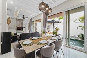 a dining room and living room with a table and chairs at Serava Villa by Kozystay - Canggu in Canggu