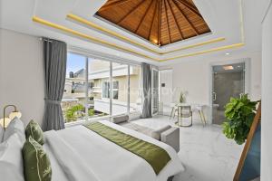 a bedroom in a villa with a large bed at Serava Villa by Kozystay - Canggu in Canggu