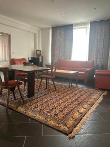 a living room with a table and a couch at Hannover Group Apartment in Hannover +1 photo
