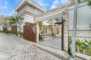a house with an open door on a street at Serava Villa by Kozystay - Canggu in Canggu