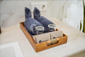 a wooden box on a counter with towels and a thread at Serava Villa by Kozystay - Canggu in Canggu +42 photos