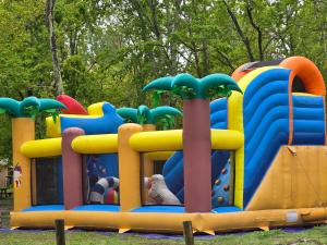 a large inflatable play structure in a park at Mobil home 3 ch 6 pers Camping Mayotte in Biscarrosse