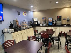 a fast food restaurant with tables and chairs at Super 8 by Wyndham Mundelein/Libertyville Area in Mundelein