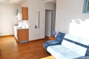 a living room with a couch and a kitchen at Résidence Helios - Studio cabine avec garage vue sur la montagne MAE-0893 in Barèges