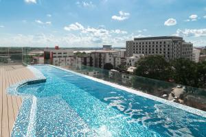 a large swimming pool on top of a building at COSI Vientiane Nam Phu in Vientiane