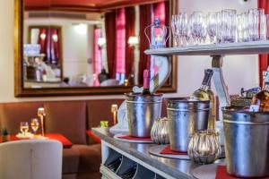 a counter with buckets and wine glasses on it at Le Cavendish in Cannes