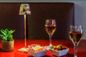 zwei Gläser Wein und Snacks auf einem Tisch in der Unterkunft Le Cavendish in Cannes + 44 Fotos