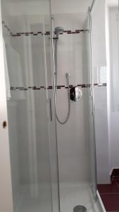 a shower with a glass door in a bathroom at La Turr De Mezz in Nesso