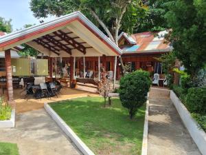 a house with a patio with a table and chairs at Alona Hidden Dream Resort by SMS Hospitality in Panglao