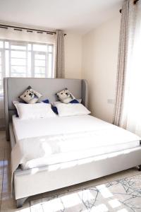 Ένα ή περισσότερα κρεβάτια σε δωμάτιο στο Haven Suites Bnb - Runogone