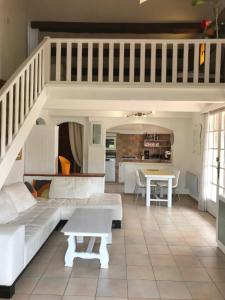 a living room with a couch and a table at 89 Le Grand Pin in Sainte-Maxime
