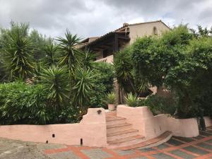a house with a staircase in front of a house at 89 Le Grand Pin in Sainte-Maxime