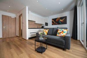 a living room with a couch and a table at Vila Katarina - Lake View Apartments in Bled