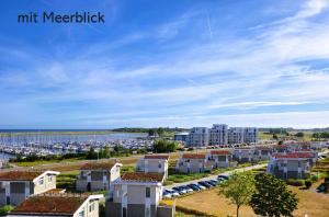 arial view of a city with buildings and a harbor at Leuchtfeuer in Wendtorf