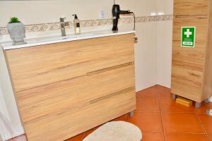 a bathroom with a sink and wooden doors at Lux Downtown Reguengos in Reguengos de Monsaraz +32 photos