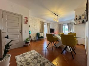 a living room with a table and chairs in it at Lux Downtown Reguengos in Reguengos de Monsaraz