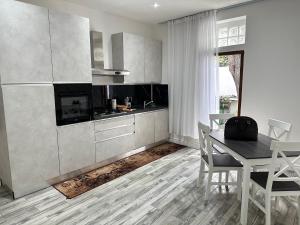 a kitchen with a table and a dining room at Amy house Olbia in Olbia