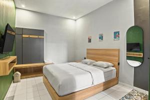 Postel nebo postele na pokoji v ubytování HUBS Hostel Yogyakarta