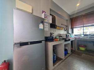 a kitchen with a large refrigerator and a counter at Modern Life Pool Villa in Hua Hin