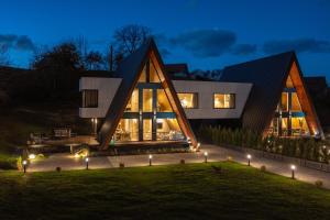 a house with a triangular roof at night at Norma Bran in Bran