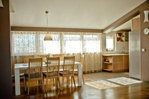 a kitchen and dining room with a table and chairs at Apartment St James in Međugorje