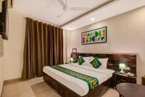Treebo Riddhi Paradise - 15 mins from Airport房間的床