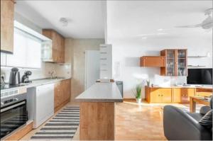 a kitchen with white appliances and wooden cabinets at Torreblanca E&S in Torrevieja