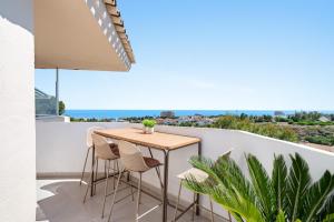 a table on the balcony of a house with a view at Secret View Riviera Del Sol in Sitio de Calahonda