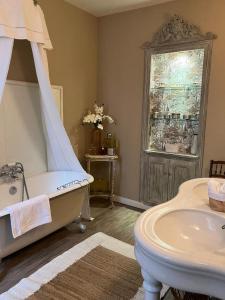 a bathroom with a bed and a tub and a sink at Maison d'Hôtes Martineau in Saint-Symphorien +33 photos