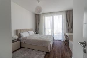 a bedroom with a bed and a desk and a window at Villa Deja Blu with Private Pool in Kalogrea +33 photos