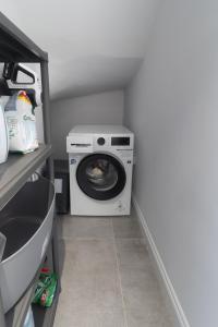 a washer and dryer sitting in a laundry room at Villa Deja Blu with Private Pool in Kalogrea