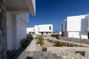 a view from the balcony of a white building at Villa Deja Blu with Private Pool in Kalogrea