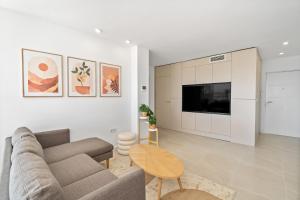 a living room with a couch and a tv at Secret View Riviera Del Sol in Sitio de Calahonda