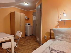 a bedroom with a bed and a desk and a table at 2-Rent Group Hostel Rooms AUB162 in Munich +284 photos