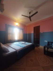 A bed or beds in a room at Krishna Inn